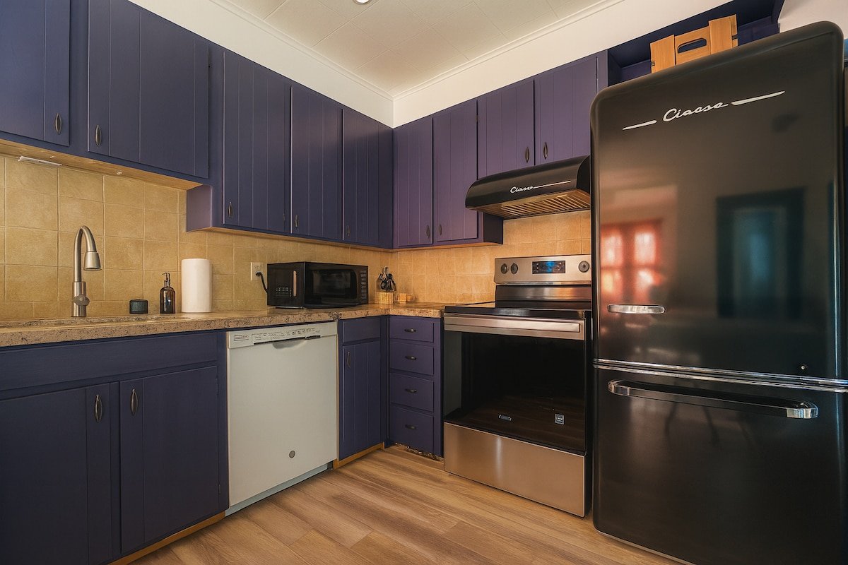 Fully equipped kitchen with colorful cabinetry at 3BR Retreat in Ellenville